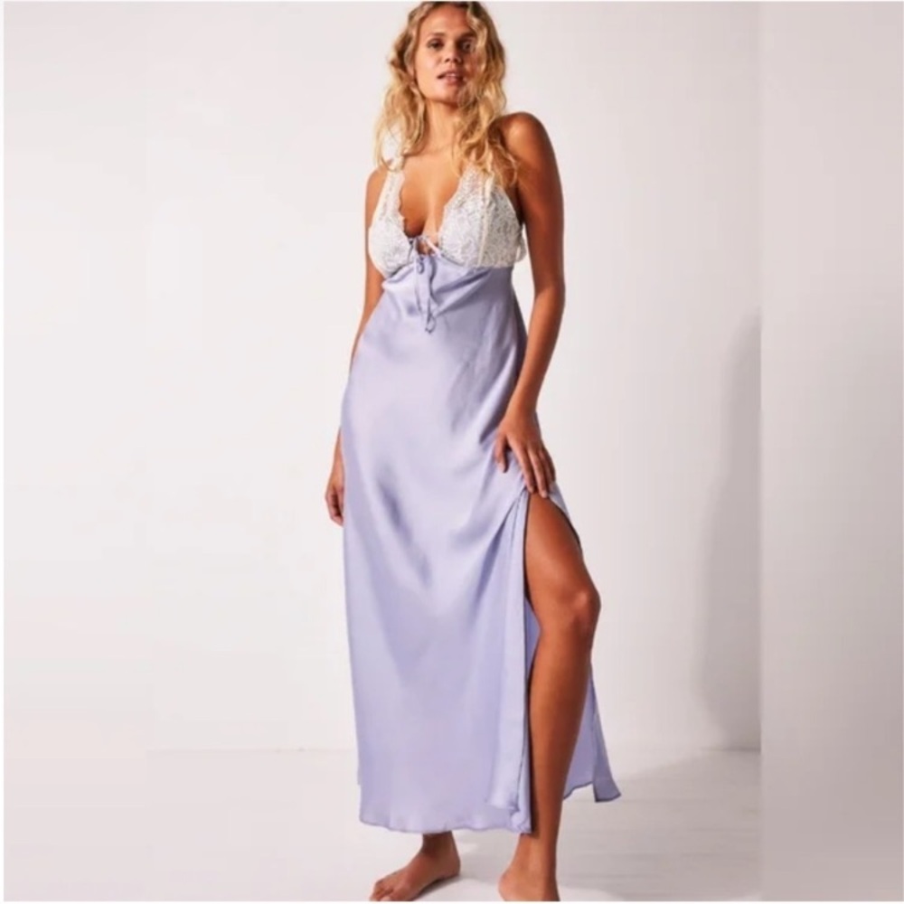 Lavender slip dress with lace detail and side slit.